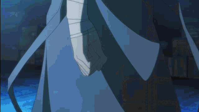 a person 's hand is reaching for a blue object