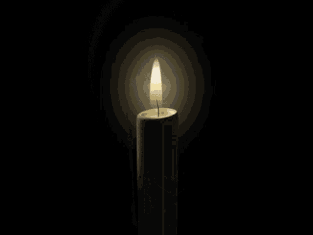 a white candle with a picture of a woman on it