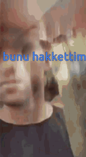 a close up of a man 's face with the words " bunu hakkattim " written on it