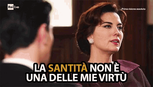 a man and woman are looking at each other and the woman says " la sanitta non e una delle mie virtu "