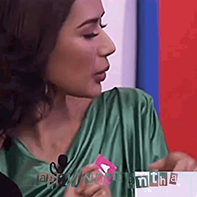 a woman in a green dress is holding a card that says happy valentine 's day on it