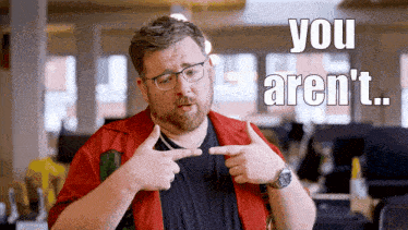 a man pointing at himself with the words you aren 't written in the background