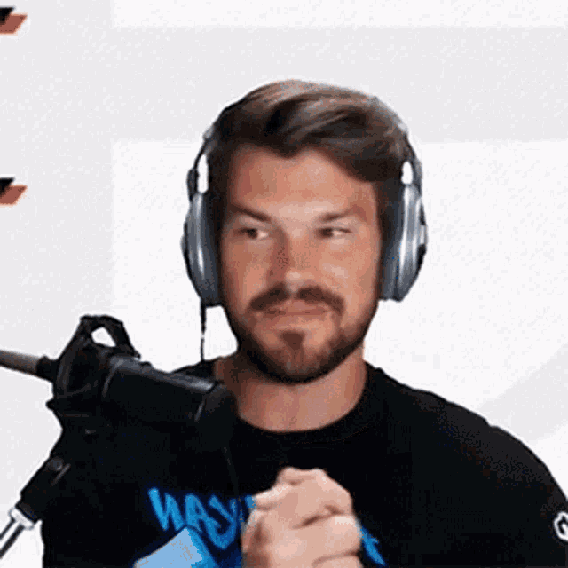a man wearing headphones and a black shirt that says wave on it