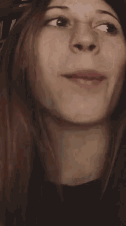 a close up of a woman 's face with her mouth open and a tooth missing .