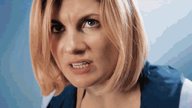 a close up of a woman 's face with her mouth open