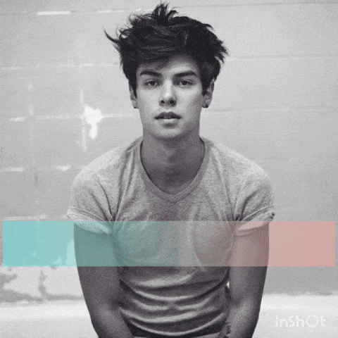a black and white photo of a young man with a blue and pink stripe behind him