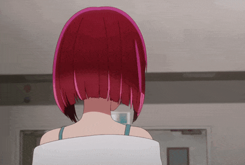 a girl with red hair is standing in front of a white wall