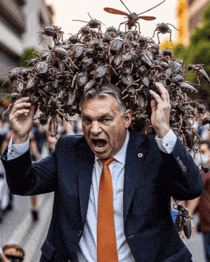 a man in a suit and tie is carrying a pile of cockroaches on his head