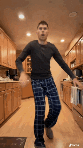 a man in plaid pajamas is dancing in a kitchen with the hashtag tiktok