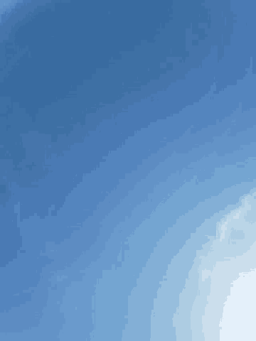 the sun is shining through the clouds in the blue sky .