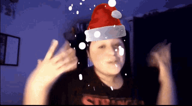 a person wearing a santa hat with snow falling on them