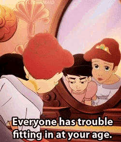 a cartoon of a girl looking at herself in a mirror with the words everyone has trouble fitting in at your age .
