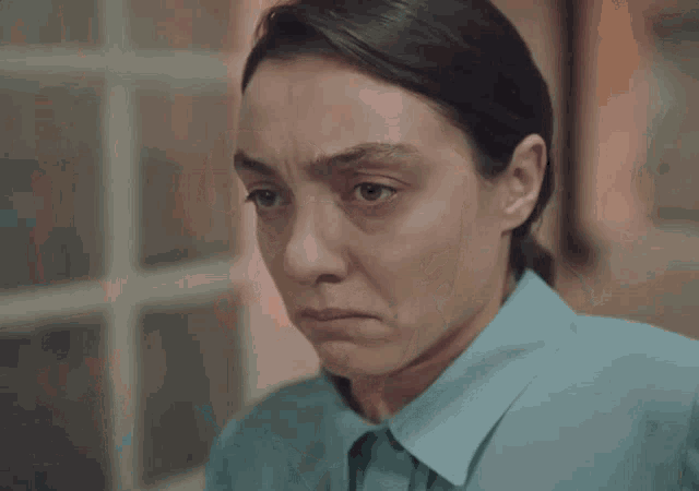 a close up of a woman 's face with a sad look on her face