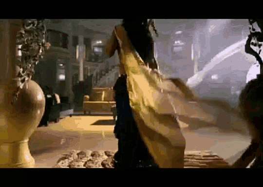 a woman in a yellow dress is standing in a room