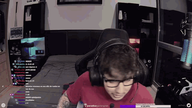 a man wearing headphones sits in front of a screen that says paradiso gaming.net