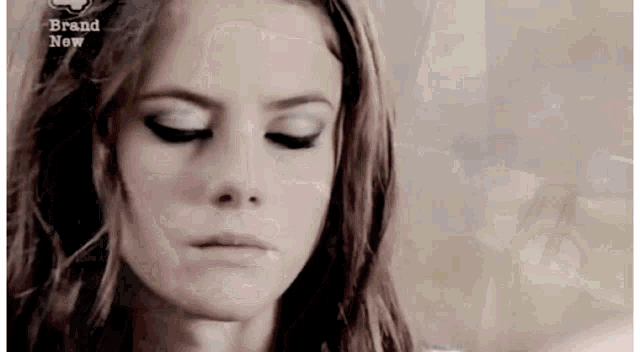 a close up of a woman 's face with the words brand new on the bottom right