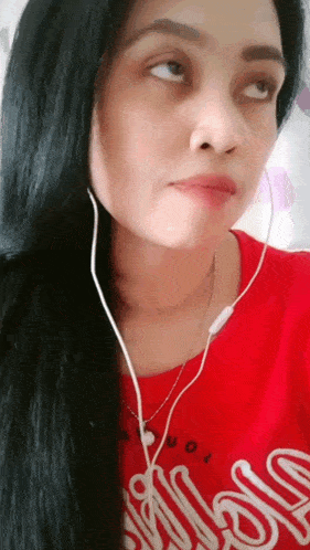 a woman wearing headphones and a red shirt that says california on it