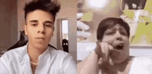 a man and a woman are making funny faces in front of a camera .