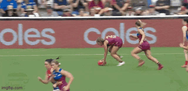 a blurred image of a soccer game with an ad for coles