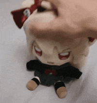 a person is holding a stuffed animal that looks like a doll .