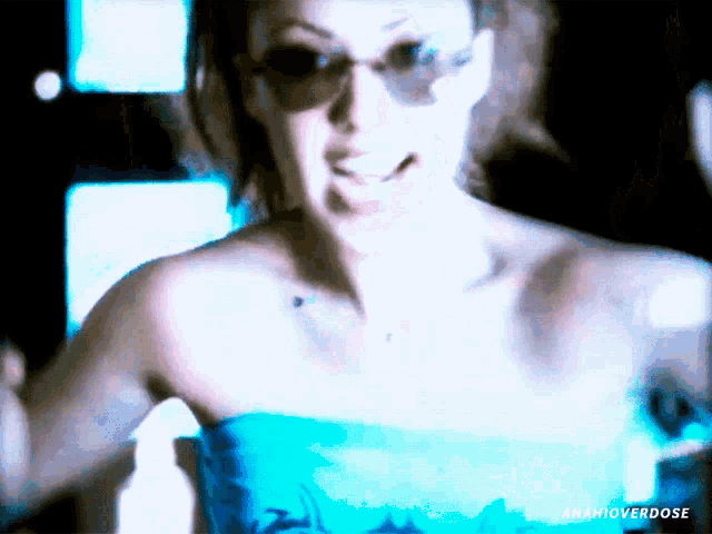 a woman wearing sunglasses and a blue top has the word anahioverdose on the bottom right