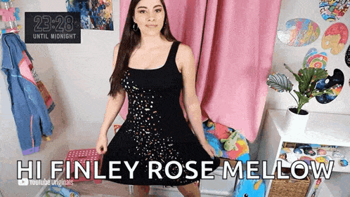 a woman in a black dress is standing in front of a clock that says until midnight