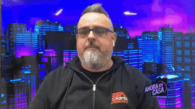 a man wearing a hoodie that says ahora el nunca