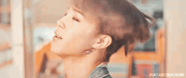 a close up of a woman 's face with a very short haircut .