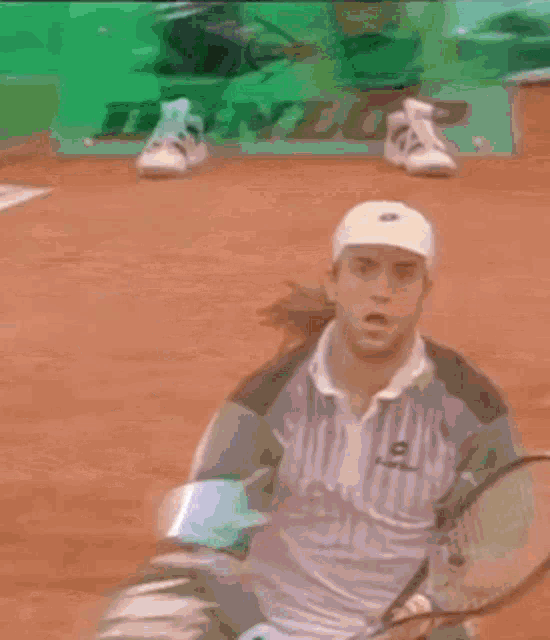 a man is holding a tennis racquet on a tennis court in front of a dunlop sign .