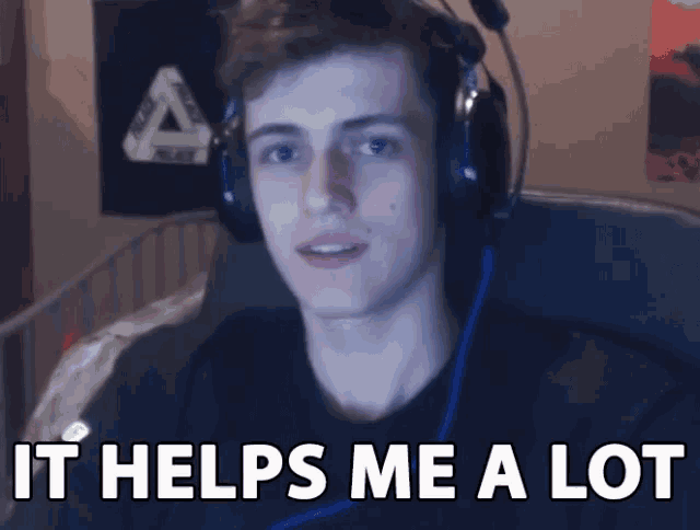 a young man wearing headphones is sitting in a chair and says it helps me a lot .