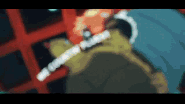 a blurred image of a person holding a sword in a video game .