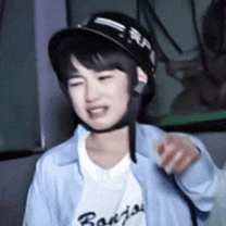 a young girl wearing a helmet and a blue shirt is sitting on a couch .