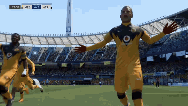 a soccer game is being played in a stadium sponsored by vodafone