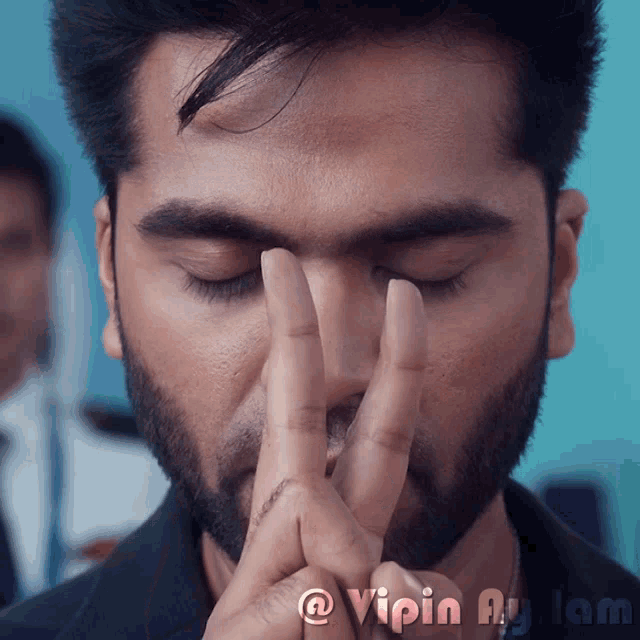 a close up of a man 's face with the words vipin aylam below