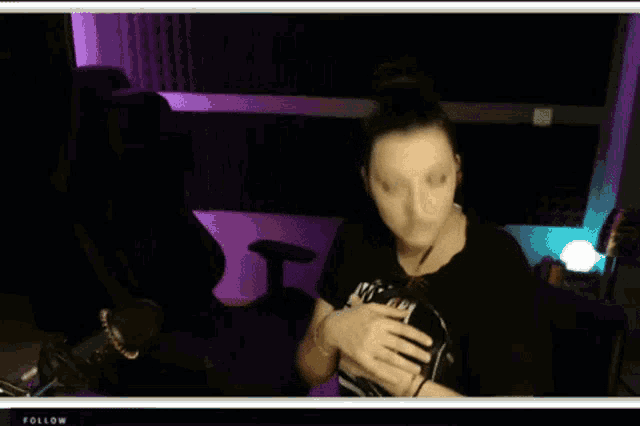a woman is wearing headphones and a black shirt that says ' i 'm a nurse ' on it