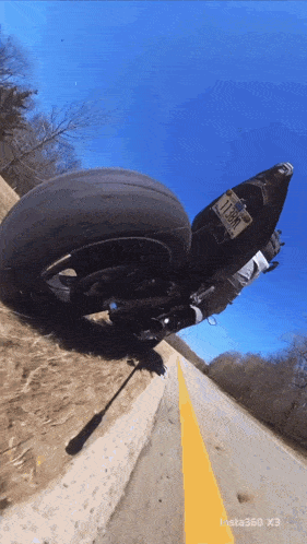 a motorcycle with a new jersey license plate is going down a dirt road
