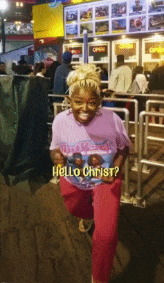 a woman wearing a t-shirt that says hello christ on it