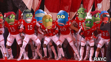 a group of football players are dancing with their heads on their jerseys including number 15