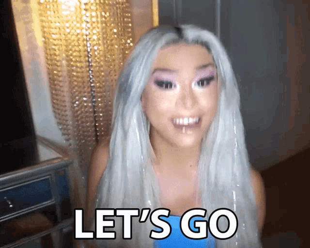 a woman says let 's go in a blue shirt