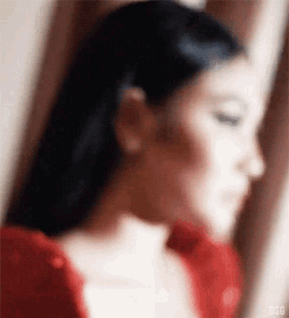 a blurry picture of a woman in a red dress