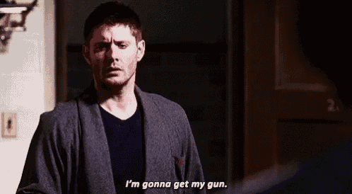 a man in a robe is standing in front of a door and saying `` i 'm gonna get my gun '' .