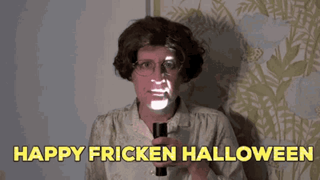 a man in a wig is holding a flashlight in front of his face and says happy fricken halloween .