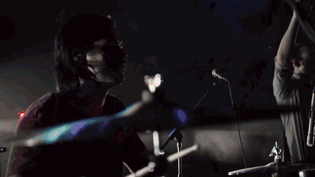 a group of people are playing instruments on a stage in front of a crowd