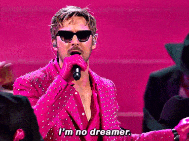 a man singing into a microphone with the words i 'm no dreamer