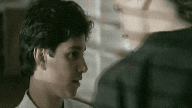 a close up of a man 's face looking at another man 's face .