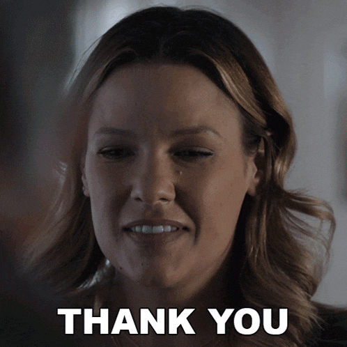 a woman with tears in her eyes and the words thank you behind her