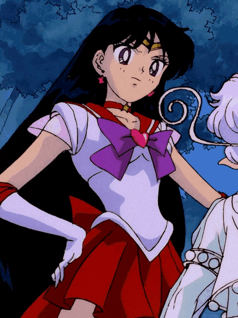 a girl in a red dress with a purple bow on her chest