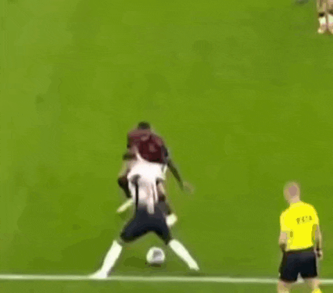 two soccer players are fighting for the ball on a field