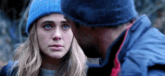 a man and a woman are looking into each other 's eyes .