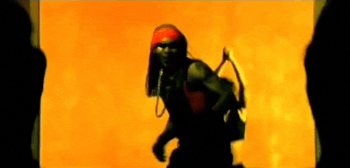 a silhouette of a man with a red bandana on his head giving the middle finger